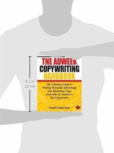 Person holding 'The Adweek Copywriting Handbook' book by Joseph Sugarman.