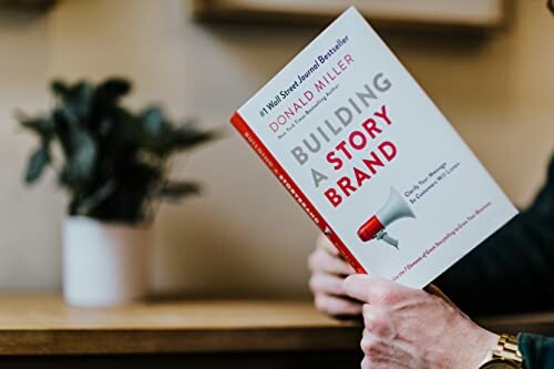 Person holding the book 'Building a StoryBrand' by Donald Miller